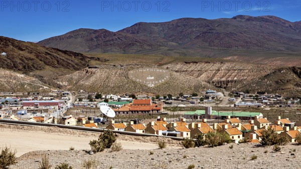 View of a small village in a hill and mountain landscape with central antenna, San Antonio de los Cobres, Salta Province, Argentina
