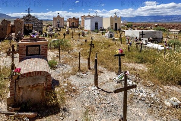 Old cemetery with graves and crosses under a blue sky with clouds, The cemetery of Cachi in Argentina