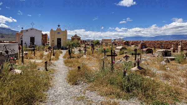 Path through an old cemetery with chapels and crosses in sunny weather, The cemetery of Cachi in Argentina