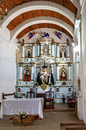 Richly decorated interior of a church with altar, figures and wooden ceiling, Iglesia San José de Cachi in Argentina