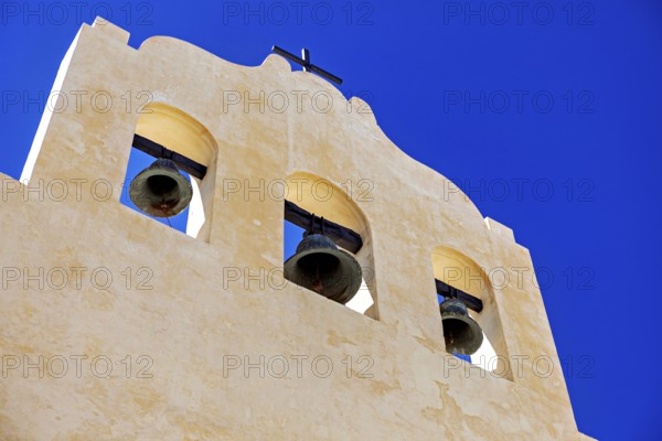 Close-up of a yellow bell tower under bright blue sky, Iglesia San José de Cachi in Argentina