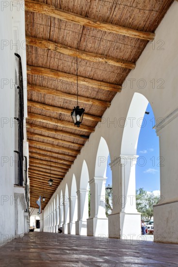 Colonial arcade with wooden roof, bright and open to the surrounding area, The arcades of Cachi in Argentina