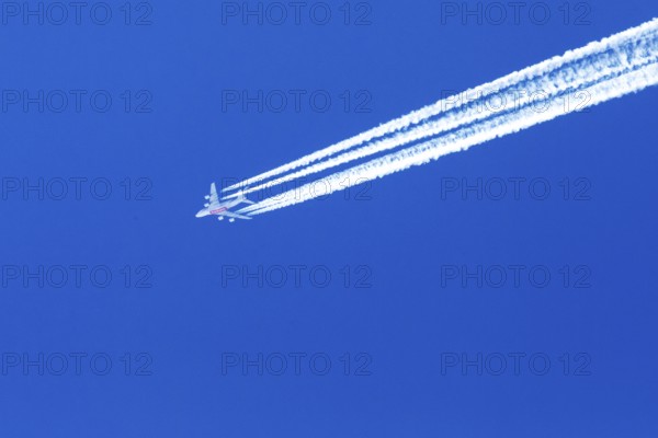 Emirates Boeing 777 flying high in the blue sky over Quebec. Province of Quebec, Canada