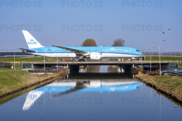 Taxiway bridge over a canal near Hoofddorp, on the Polderbaan, a runway in the west of Amsterdam Schiphol Airport, KLM Boeing 787 Dreamliner, aircraft rolls to the terminal after landing, Netherlands