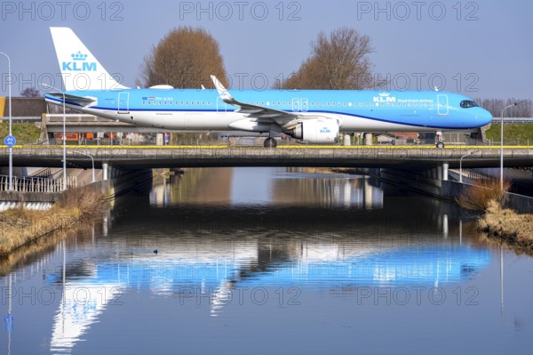 Taxiway bridge over a canal near Hoofddorp, on the Polderbaan, a runway in the west of Amsterdam Schiphol Airport, KLM Airbus A321neo, aircraft rolls to the terminal after landing, Netherlands