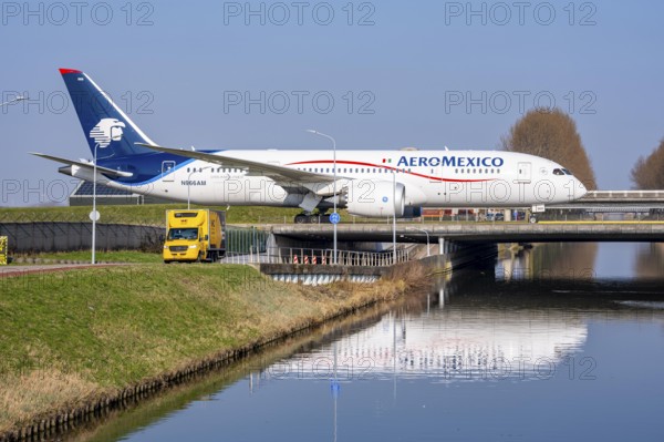 Taxiway bridge over a canal near Hoofddorp, on the Polderbaan, a runway in the west of Amsterdam Schiphol Airport, Boeing 787-8 Dreamliner Aeromexico, aircraft rolls to the terminal after landing, Netherlands