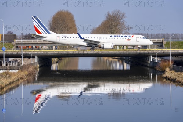 Taxiway bridge over a canal near Hoofddorp, on the Polderbaan, a runway in the west of Amsterdam Schiphol Airport, Air France HOP Embraer 190, aircraft rolls to the terminal after landing, Netherlands