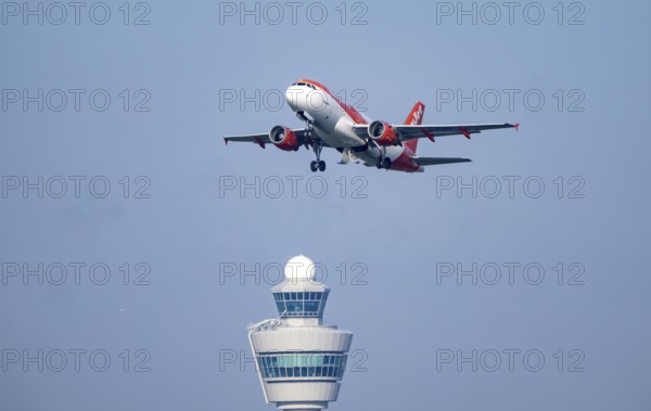 Easyjet Airbus A319 aircraft takes off from Kaagbaan runway, 06/24, at Amsterdam Schiphol Airport, AMS, Air Traffic Control Tower, Netherlands