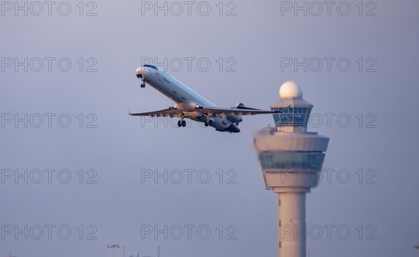 Lufthansa cityline aircraft takes off from Kaagbaan runway, 06/24, at Amsterdam Schiphol Airport, AMS, air traffic control tower, the Netherlands