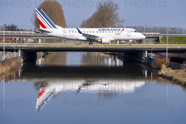 Taxiway bridge over a canal near Hoofddorp, on the Polderbaan, a runway in the west of Amsterdam Schiphol Airport, Air France HOP Embraer 170, aircraft rolls to the terminal after landing, Netherlands