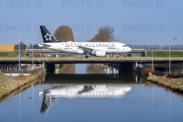 Taxiway bridge over a canal near Hoofddorp, on the Polderbaan, a runway in the west of Amsterdam Schiphol Airport, Lufthansa Airbus A319, Star Alliance, aircraft rolls to the terminal after landing, Netherlands