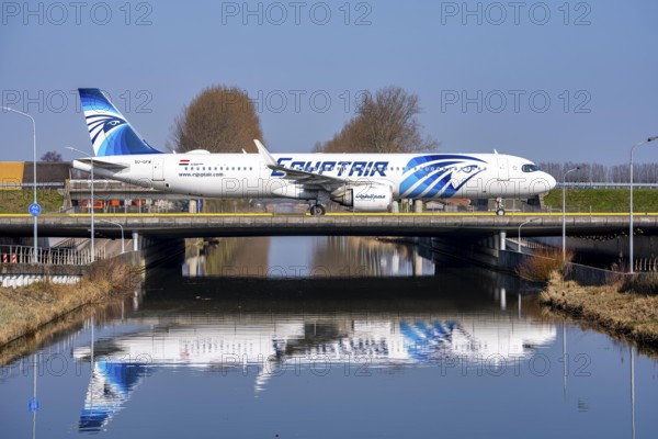 Taxiway bridge over a canal near Hoofddorp, on the Polderbaan, a runway in the west of Amsterdam Schiphol Airport, Egyptair Airbus A321neo, aircraft rolls to the terminal after landing, Netherlands