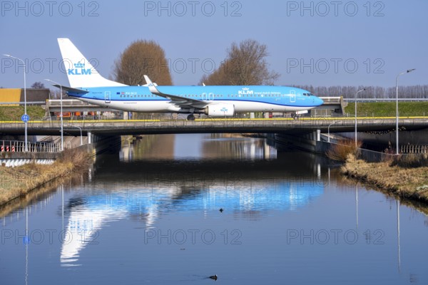 Taxiway bridge over a canal near Hoofddorp, on the Polderbaan, a runway in the west of Amsterdam Schiphol Airport, KLM Boeing 737-800, aircraft rolls to the terminal after landing, Netherlands