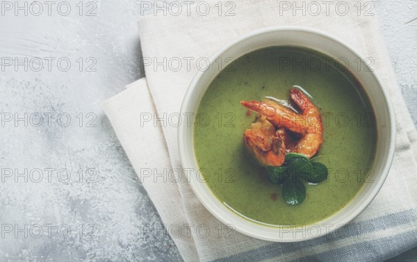 Pea cream soup, with shrimp, green soup, homemade, top view, no people