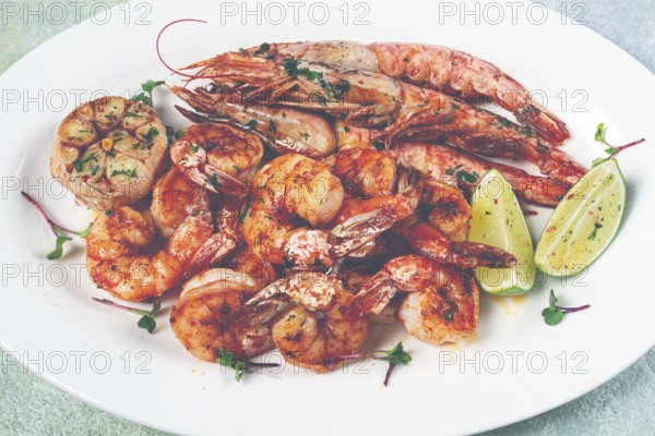 Fried langoustines and tiger shrimps, with spices and herbs, homemade dish, without people