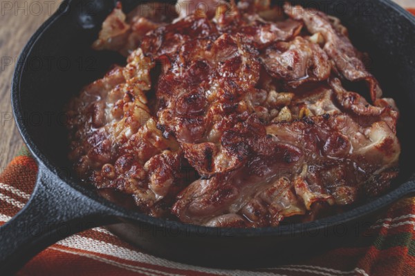 Crispy bacon, on a cast-iron skillet, on a wooden table, rustic style, no people