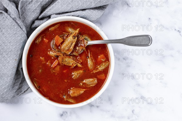 French shrimp bisque soup, on a marble table, close-up, no people
