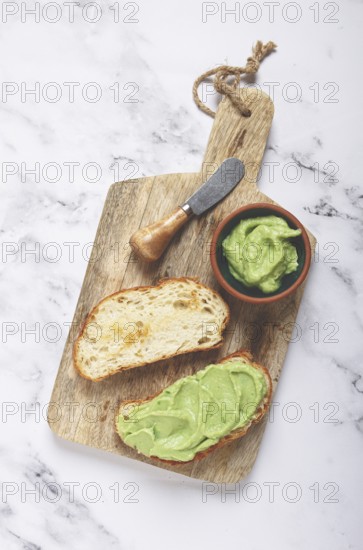 Ciabatta with avocado pasta, breakfast, on a chopping board, top view, homemade, no people