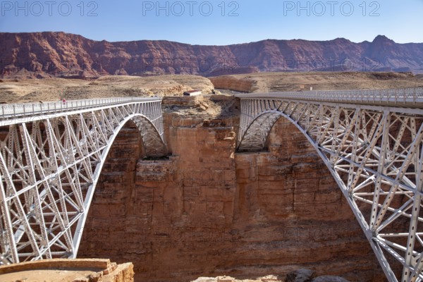 Marble Canyon, Arizona - The historic Navajo Bridge (left), now a pedestrian bridge, over the Colorado River at the north end of the Grand Canyon. The newer bridge at right carries Highway 89A