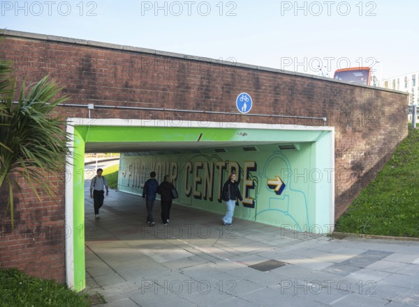 People walking through underpass subway at North Cross roundabout city centre of Plymouth, Devon, England, UK