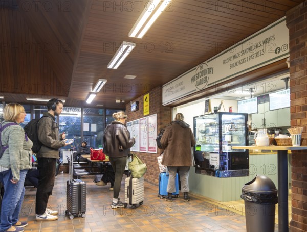 Passengers queuing at The Westcountry Larder Coffee takeaway shop shop, Tiverton Parkway railway station, Somerset, England, UK