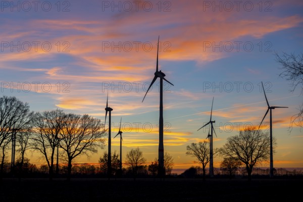 Neudersum wind farm, near Rhede, a total of 13 wind turbines generate electricity here, rated output of 59 MW, Nordex and Enercon wind turbines, sunset, Lower Saxony, Germany