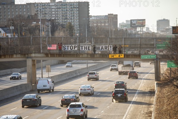 Detroit, Michigan USA - 2 March 2026 - Signs are posted on a pedestrian crosswalk over a freeway calling for an end to the U.S. wer against Iran