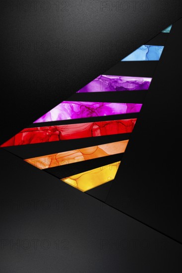 Colorful abstract design with geometric shapes in vivid hues on paper. Dynamic contrast of purple, red, and orange against a black background, creating a modern, energetic visual