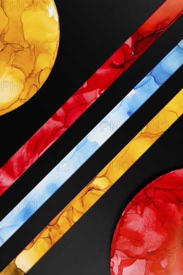 A vibrant abstract image featuring colorful geometric shapes on paper. Bold red, yellow, and blue inks create a dynamic pattern against a black background, highlighting contrast and creativity