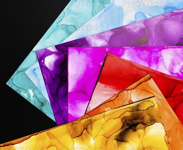 A collection of vibrant abstract ink backgrounds showcasing various vivid colors on paper. Perfect for creative designs, these textures highlight fluidity and depth in each hue