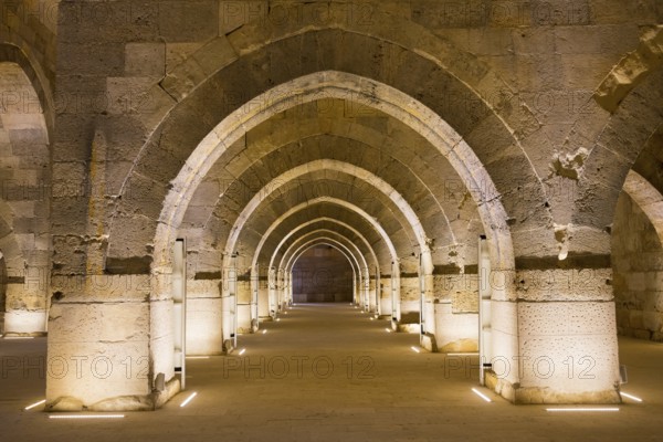 Long stone tunnel with alternating arches in warm light, Sultanhani caravanserai, on the former Silk Road, museum, Sultanhani Kervansaray, Sultanhani, Aksaray province, Turkey