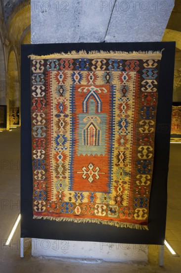 Colorful, traditional rug with detailed patterns displayed in a room, Sultanhani caravanserai, on the former Silk Road, museum, Sultanhani Kervansaray, Sultanhani, Aksaray province, Turkey