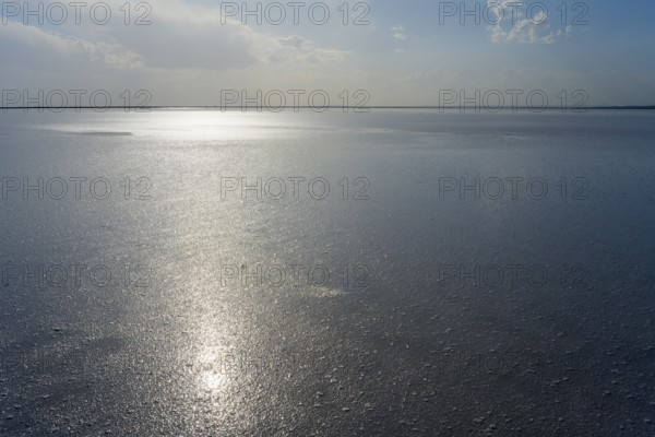 Wide, peaceful expanse of water with bright sunlight and cloudy sky, salt lake, Tuz Gölü, located between Konya, Aksaray and Ankara, Turkey