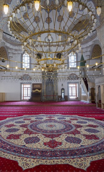 Magnificent interior of a mosque with a large chandelier and richly decorated carpet, illuminated by windows, Selimiye Mosque, Konya Sultan Selim Camii, Konya, Central Anatolia, Turkey