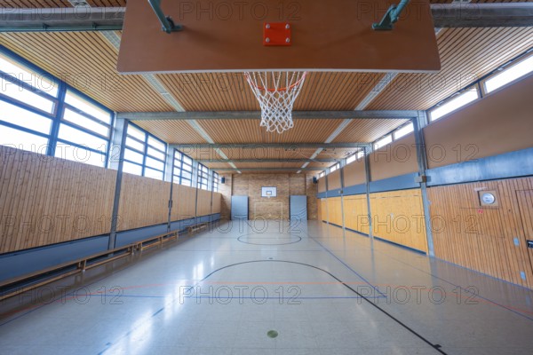 Large, bright gym with basketball hoop and floor markings, Schlehengäu Grund Schule Gechingen, Calw district, Germany