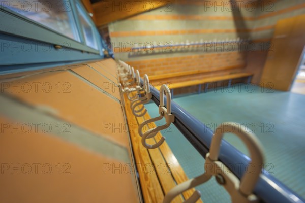 Close-up view of hooks and blue tiles in a functional room, Schlehengäu Grund Schule Gechingen, Calw district, Germany
