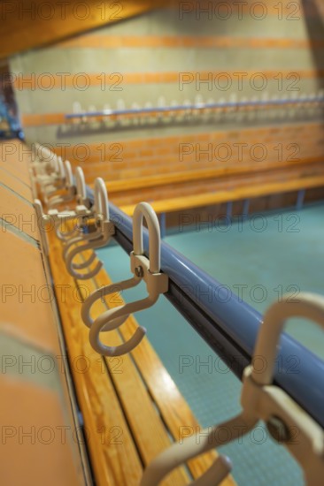 Close-up of a series of hooks in a changing room with blue tiles, Schlehengäu Grund Schule Gechingen, Calw district, Germany