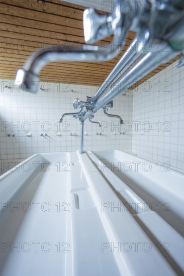Close-up of a laundry room with silver faucets and white ceramic sinks, Schlehengäu Grund Schule Gechingen, Calw district, Germany