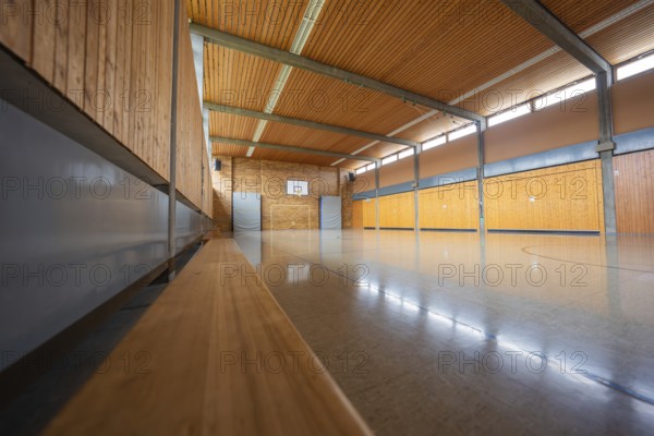 Empty sports hall with wooden walls and a basketball hoop in a quiet atmosphere, Schlehengäu Grund Schule Gechingen, Calw district, Germany