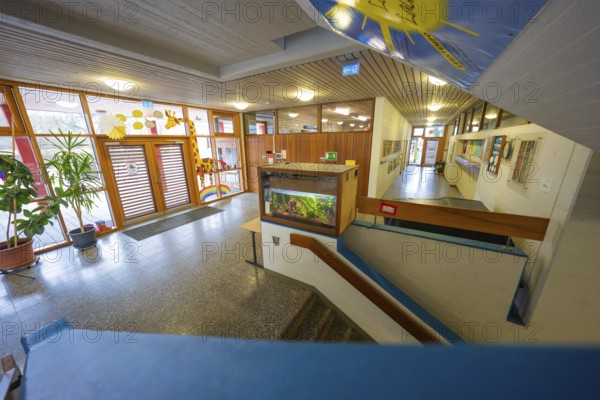 Inviting entrance area with colorful decorations and wooden paneling, Schlehengäu Grund Schule Gechingen, Calw district, Germany