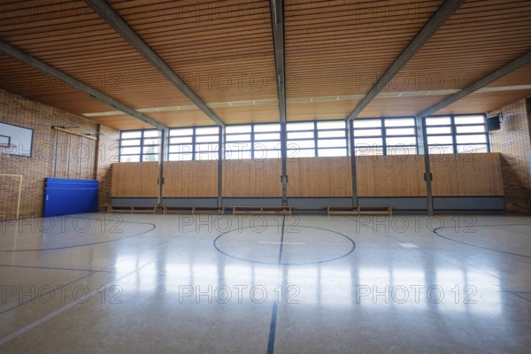 Large, empty gym with wooden floors and windows that let in natural light, Schlehengäu Grund Schule Gechingen, Calw district, Germany