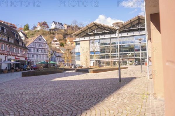 Town square with a mix of modern and traditional architecture in sunny weather, Calw, Calw district, Germany