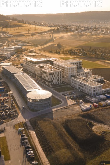 Industrial complex with modern buildings in a rural area with fields, new hospital at the Calw health campus, Calw district, Germany