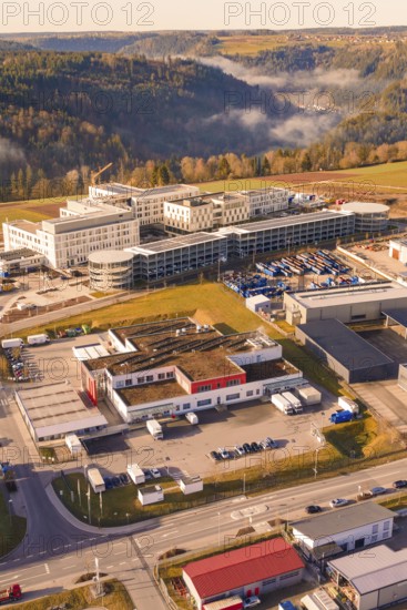 Industrial building on the edge of a forest with hills in the background, new hospital at the Calw health campus, Calw district, Germany
