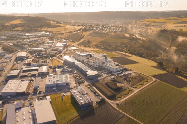 Extensive industrial area against a rural backdrop at golden hour, new hospital at Calw Health Campus, Calw district, Germany