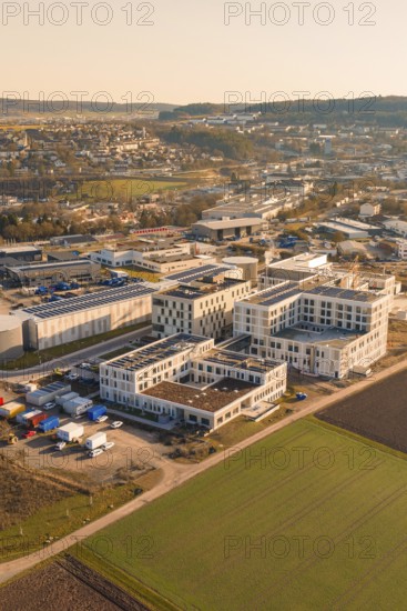 Panoramic view of an urban environment, modern buildings and surrounding fields in morning light, new hospital at Calw Health Campus, Calw district, Germany