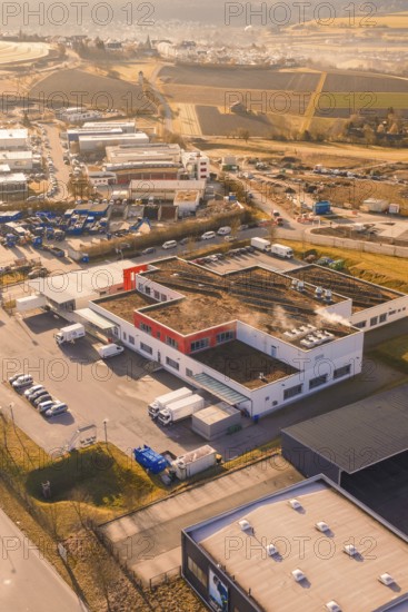 Industrial complex with warehouses and vehicles on the outskirts of a city, new hospital on the Calw health campus, Calw district, Germany