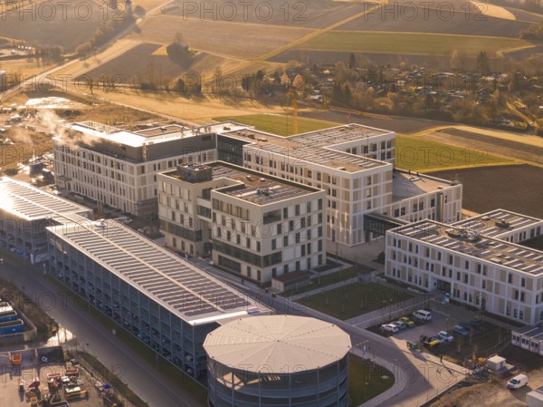Modern buildings in a rural region with fields and autumn sounds in the evening light, new hospital at the Calw health campus, Calw district, Germany