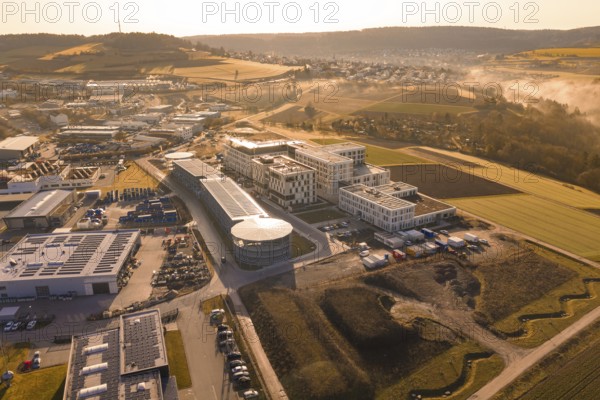 Industrial area and fields viewed from above in morning fog, new hospital at Calw Health Campus, Calw district, Germany