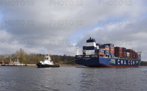 Container ship CMA CGM RUNDALE and tugboat STEIN sail in the Kiel Canal, NOK, Kiel Canal, Kiel Canal, Schleswig-Holstein, Germany